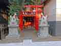 池袋の住宅街にある池袋御嶽神社の赤い鳥居と狛狐の像。
